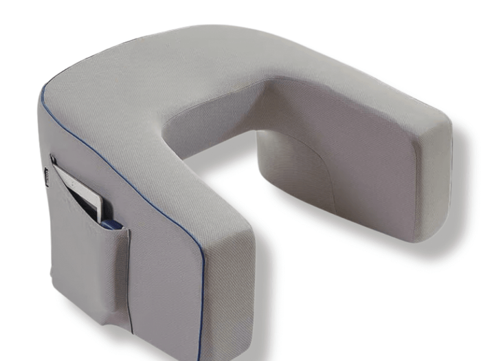 The grey U-shaped lap desk pillow in its cover, side pocket in front
