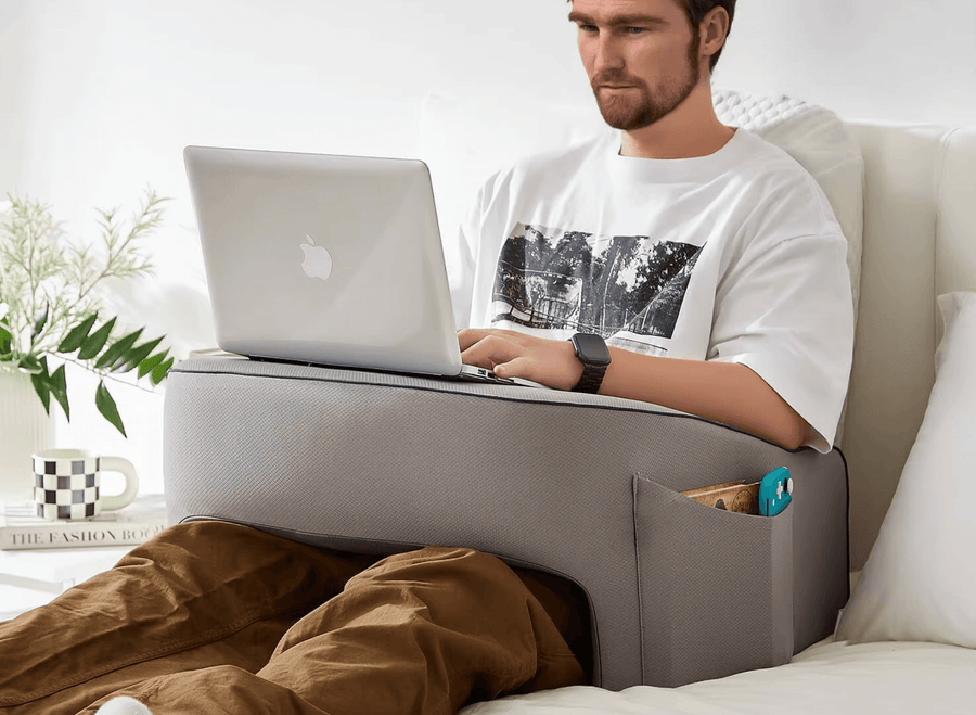 Man with a laptop on the pillow