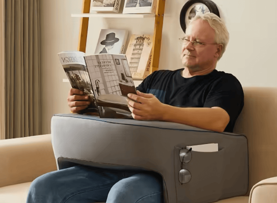 Man reading with his forearms on the Lap Desk Pillow